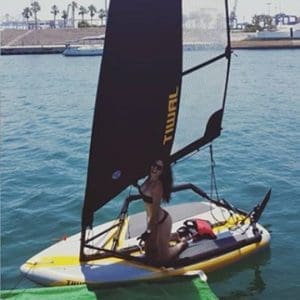 Woman sailing the Tiwal 3 inflatable sailboat in Spain