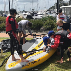 Kids assembling Tiwal 3 inflatable sailing boat in New Zealand