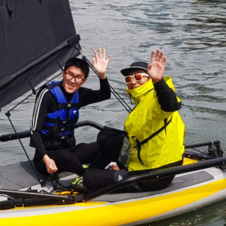 Adults trying Tiwal 3 inflatable sailboat in South Korea
