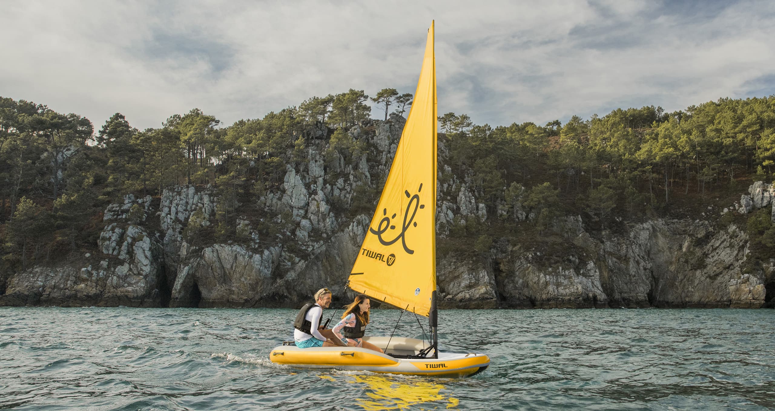 Couple navigating on the Tiwal 2L family sailboat