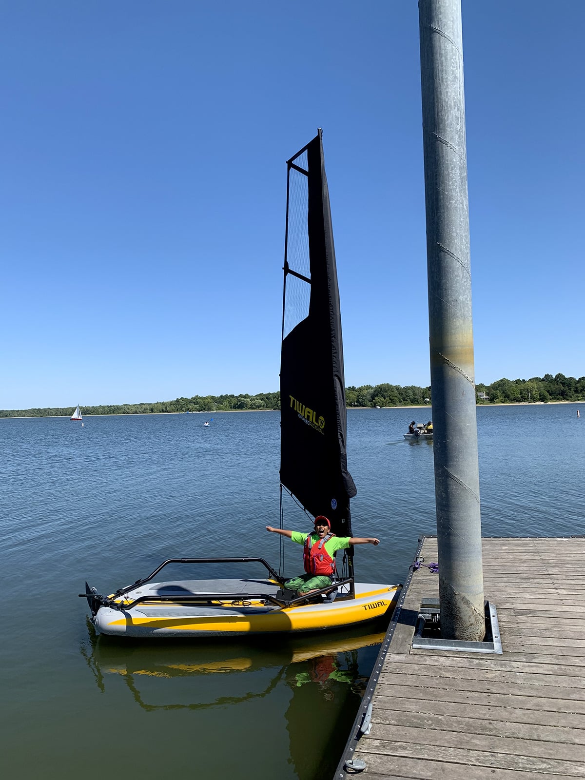 Saket's son at the dock on their Tiwal 3 sailing dinghy