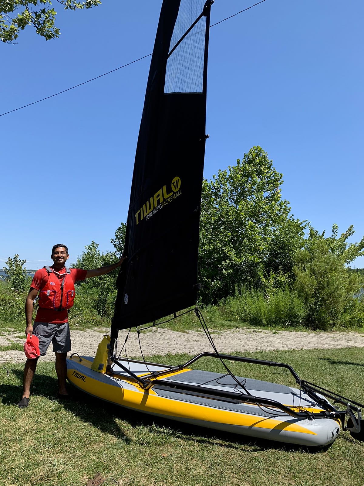 Sahket next to his Tiwal 3 Sailing dinghy